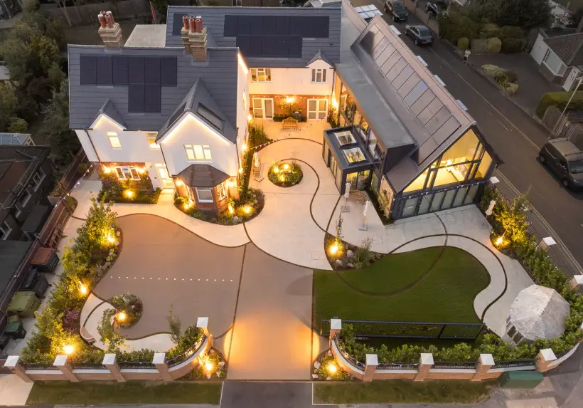 Place Farm House garden design from an aerial view at night, showcasing warm outdoor lighting